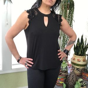 Sleeveless black top with lace and tie front